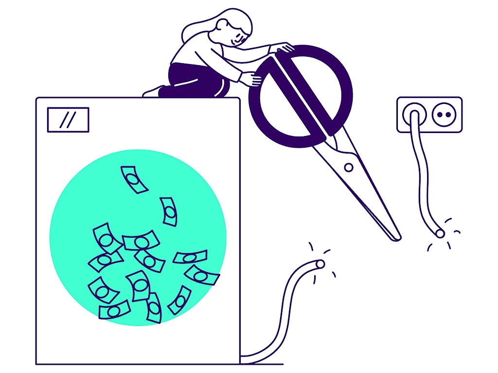Picture of someone cutting the power cord of a washing machine that has money in it